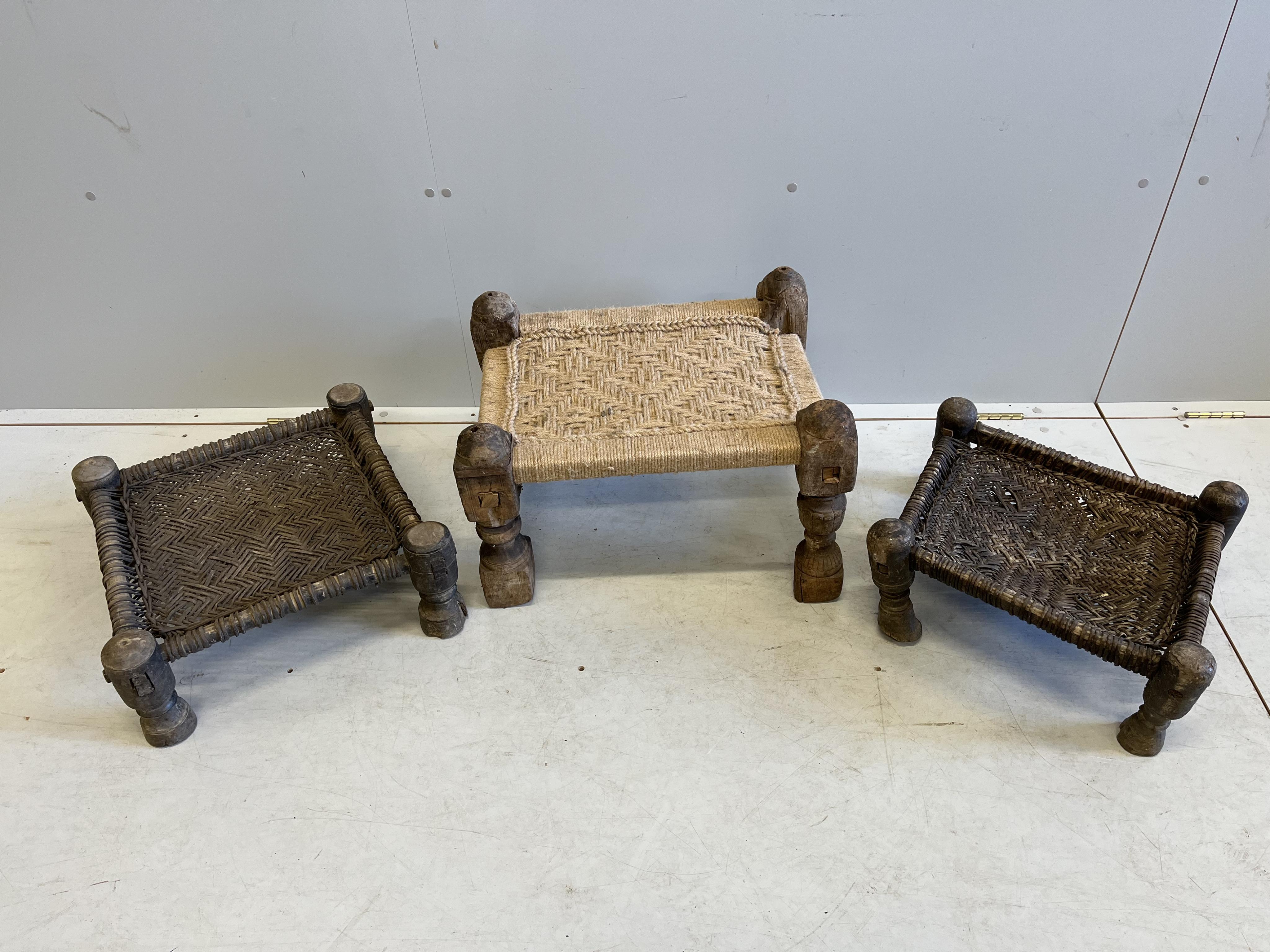Three rectangular African hardwood stools with woven seats, largest width 56cm, depth 43cm, height 35cm. Condition - poor